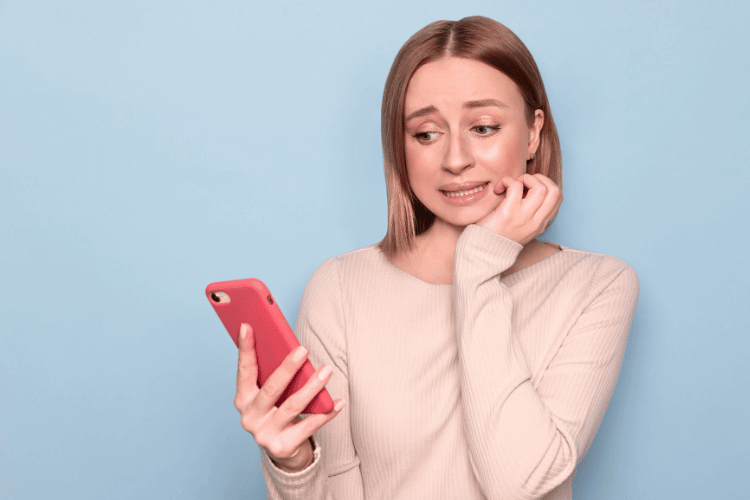 Nervous Woman Looking at Her Mobile Phone