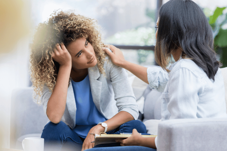 Upset woman talks with mental health professional